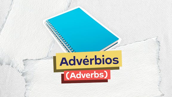 Frase "Advérbios (Adverbs)" centralizada e, logo acima, a imagem de um caderno de estudos.